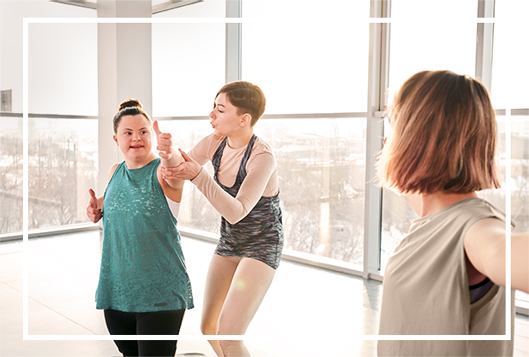 A photo of a resident exercising with a staff member