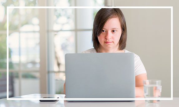 A girl typing on a laptop