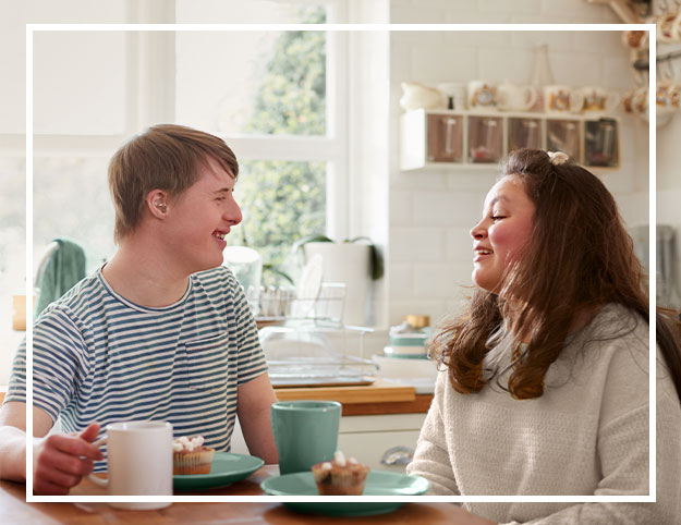 A photo of two people talking during breakfast