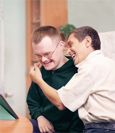 A photo of smiling residents hugging each other